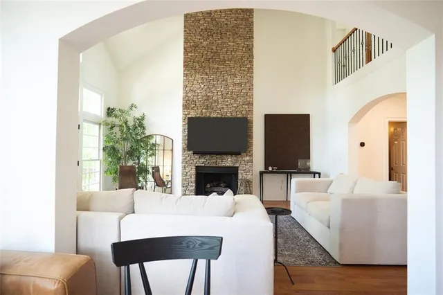 a living room with fireplace furniture and a flat screen tv