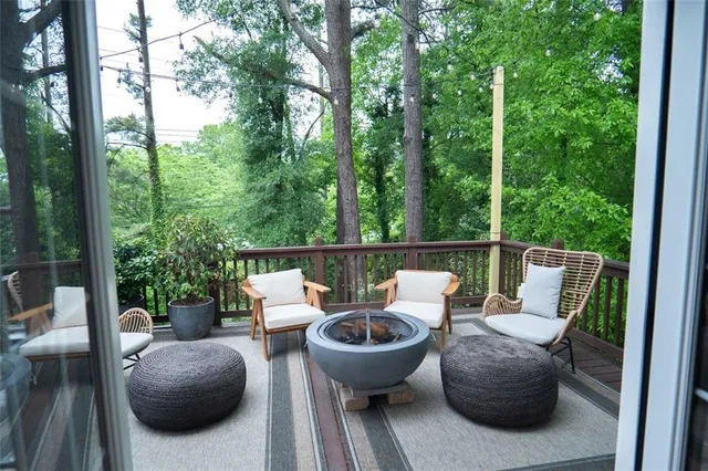 a view of two chairs and table in the balcony