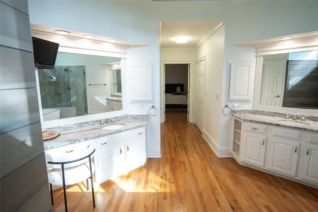 a spacious bathroom with a granite countertop sink mirror and shower