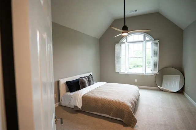 a view of a livingroom with a ceiling fan and window