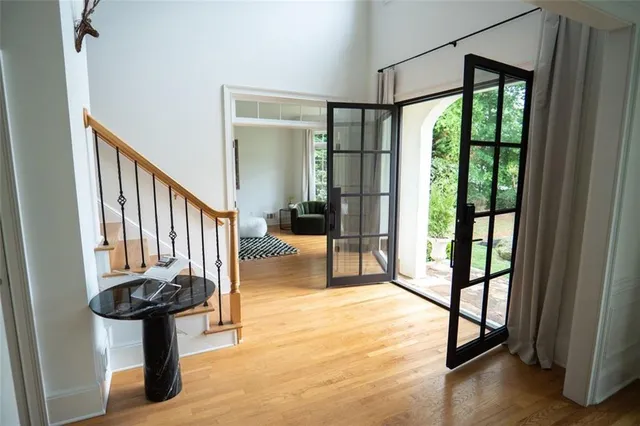 a view of a hallway with wooden floor and staircase