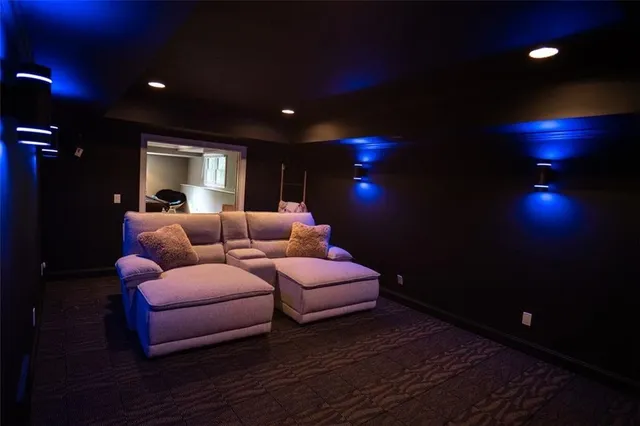 a living room with stainless steel appliances kitchen island furniture and a window