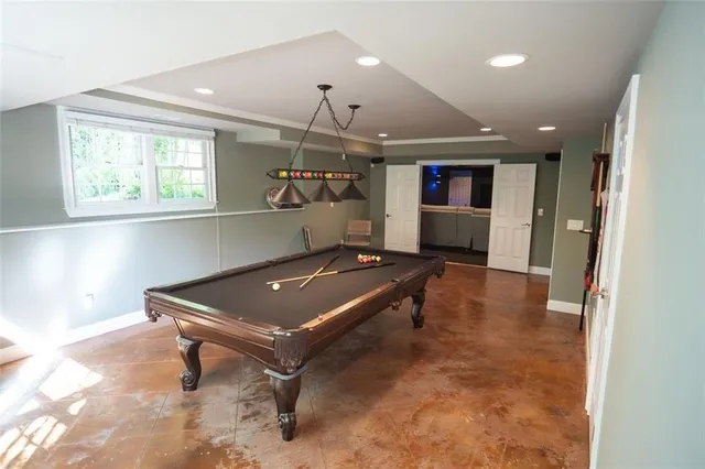 a kitchen with a sink and a stove top oven with wooden floor