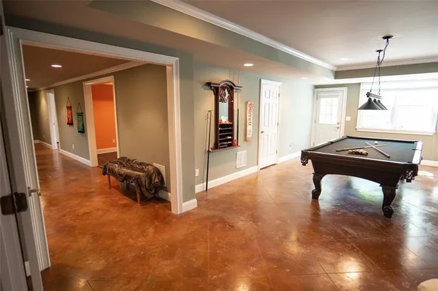 a spacious bedroom with a bed and a window