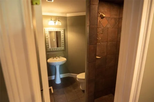 a view of a balcony with chairs and a potted plant