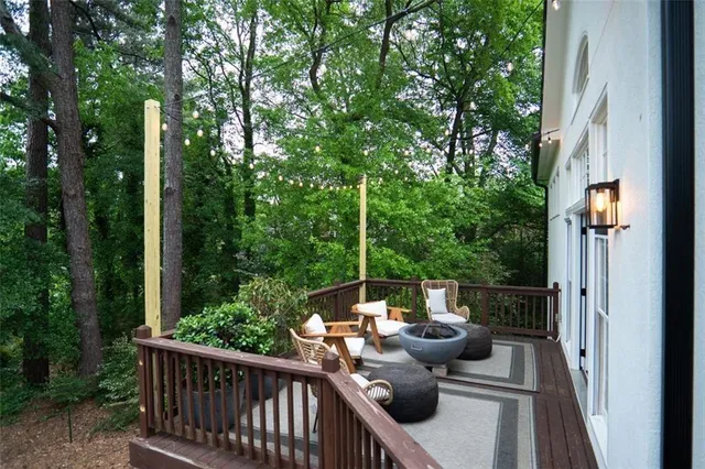 a view of a house with backyard and deck