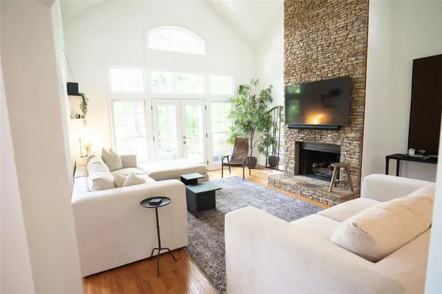 a living room with furniture a flat screen tv and a fireplace