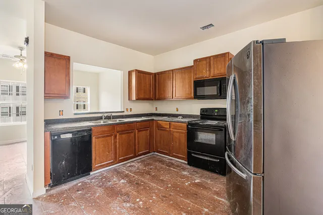 a kitchen with stainless steel appliances granite countertop a refrigerator stove and sink