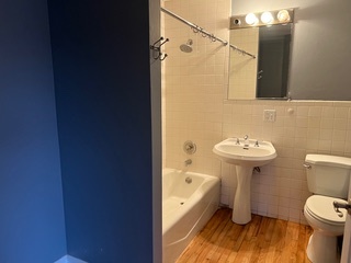 1215 West Grand Avenue, Unit 3F Chicago, IL 60642 - Photo 11 of 15 a bathroom with a sink a toilet and shower