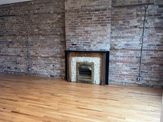1215 West Grand Avenue, Unit 3F Chicago, IL 60642 - Photo 3 of 15 a view of empty room with a fireplace