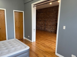 1215 West Grand Avenue, Unit 3F Chicago, IL 60642 - Photo 5 of 15 a view of a hallway with wooden floor and closet