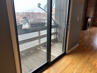1215 West Grand Avenue, Unit 3F Chicago, IL 60642 - Photo 7 of 15 a view of a glass door and a yard from a window