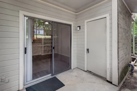 a bathroom with a glass door and shower