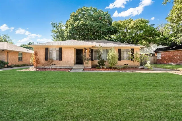 a front view of house with yard and outdoor seating