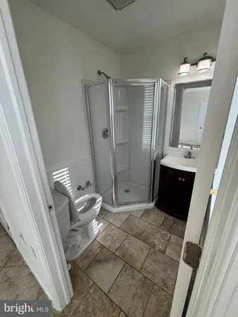 a bathroom with a sink and mirror with bathtub