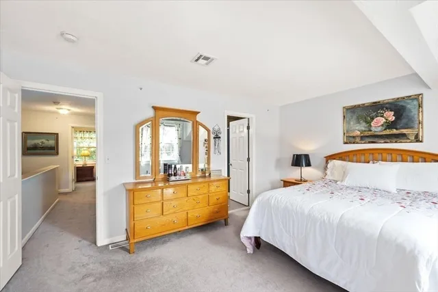 a bedroom with a large bed and a view of bedroom