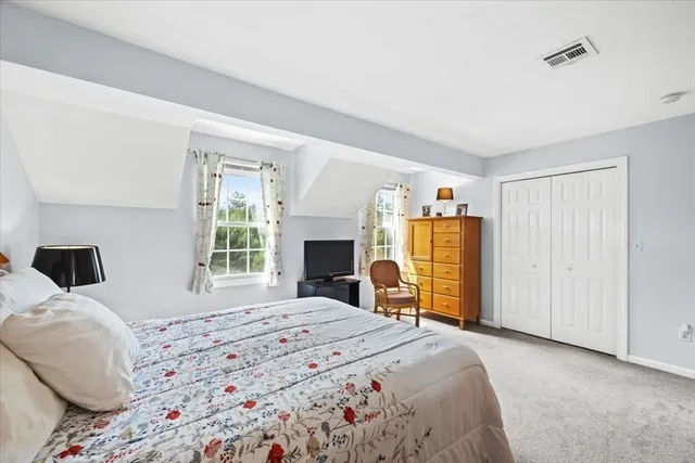 a bedroom with a large bed and a dresser