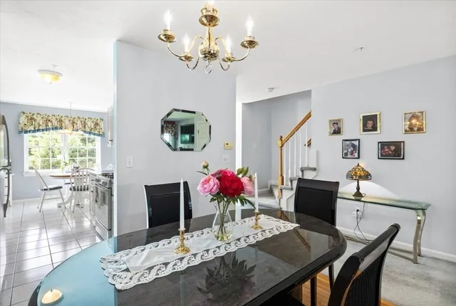 a view of a dining room with furniture a potted plant and wooden floor