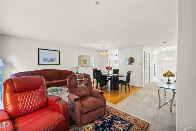 a living room with furniture kitchen view and a dining table