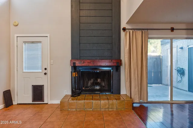 a view of an empty room with fire place and a fireplace
