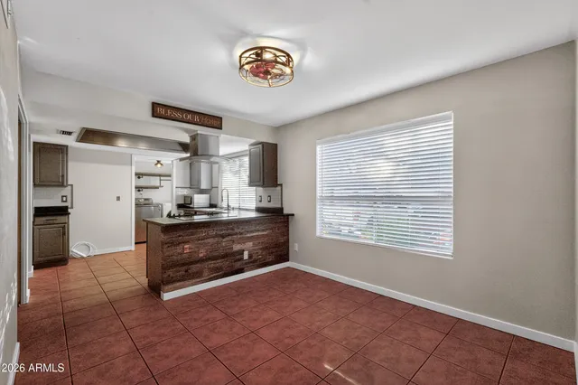 a kitchen with stainless steel appliances granite countertop a stove a refrigerator and a sink