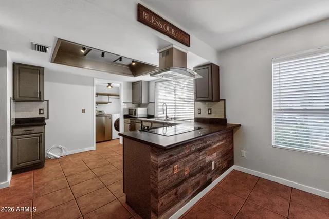 a kitchen with stainless steel appliances granite countertop a stove a sink dishwasher and a refrigerator