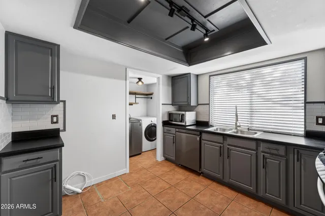 a kitchen with stainless steel appliances granite countertop a refrigerator and a stove