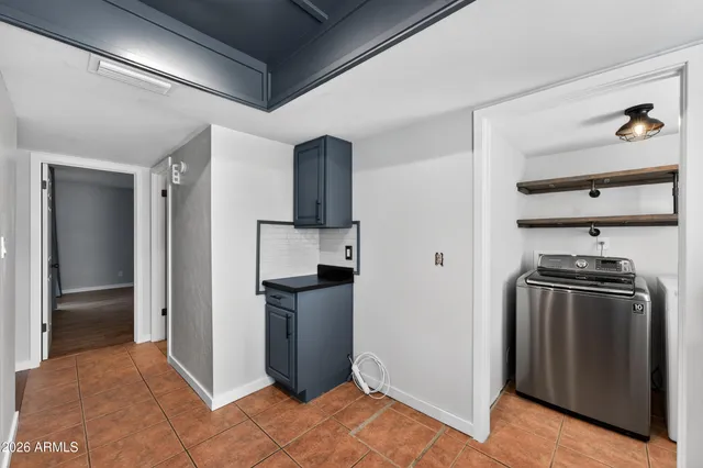 a kitchen with stainless steel appliances granite countertop a sink a stove a refrigerator cabinets and a window