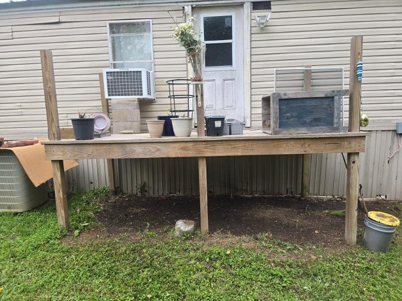 390 Campground Road Trinity, TX 75862 - Photo 36 of 37 Rear wood-frame deck with access door, featuring vinyl siding exterior and a window-mounted air conditioning unit