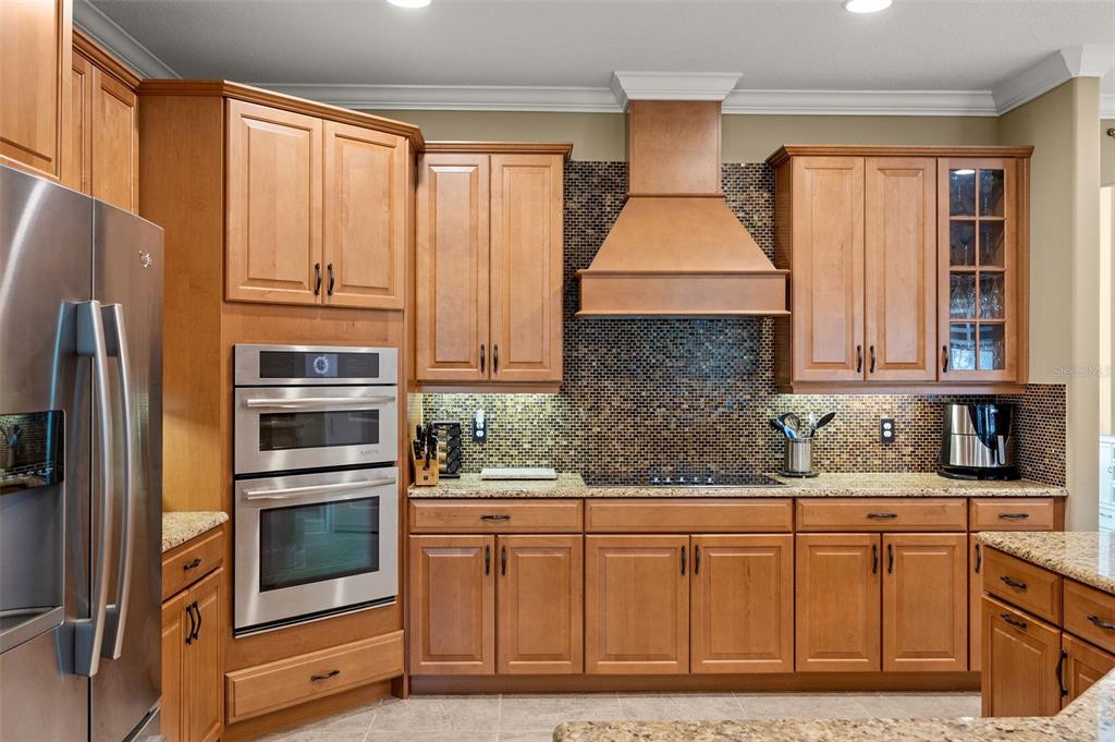 8692 Crested Eagle Place Sanford, FL 32771 - Photo 17 of 56 a kitchen with stainless steel appliances granite countertop a refrigerator and a stove top oven