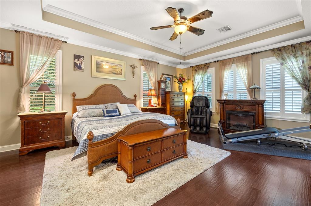 8692 Crested Eagle Place Sanford, FL 32771 - Photo 25 of 56 a bedroom with a bed a dresser and flat screen tv