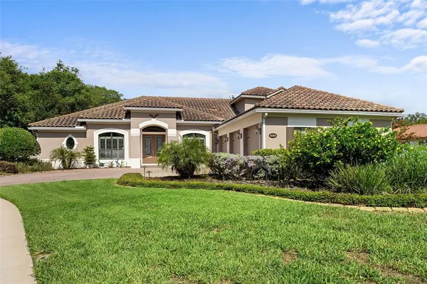 a front view of house with yard and green space