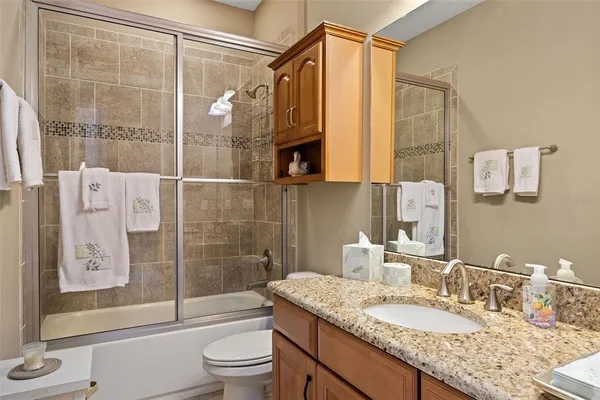 a bathroom with a sink a toilet and bathtub