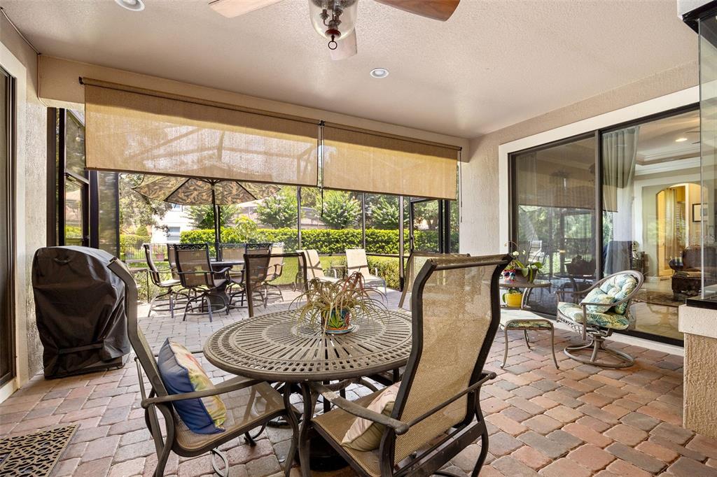 8692 Crested Eagle Place Sanford, FL 32771 - Photo 37 of 56 a dining room with furniture a chandelier and glass windows