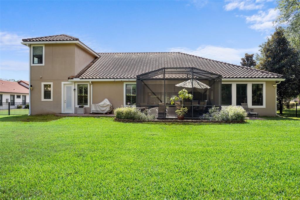8692 Crested Eagle Place Sanford, FL 32771 - Photo 46 of 56 a front view of a house with garden