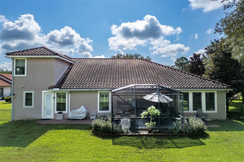 8692 Crested Eagle Place Sanford, FL 32771 - Photo 5 of 56 a front view of a house with a garden and porch