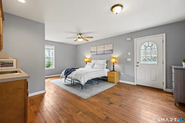 a bedroom with a bed window and couch