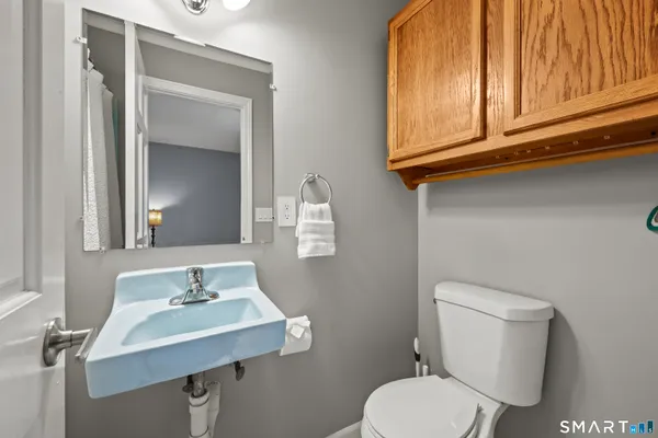 a spacious bedroom with a large bed and a chandelier