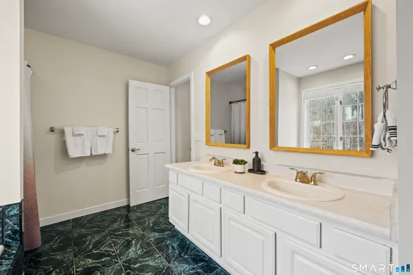 a en suite bathroom with a sink and a mirror