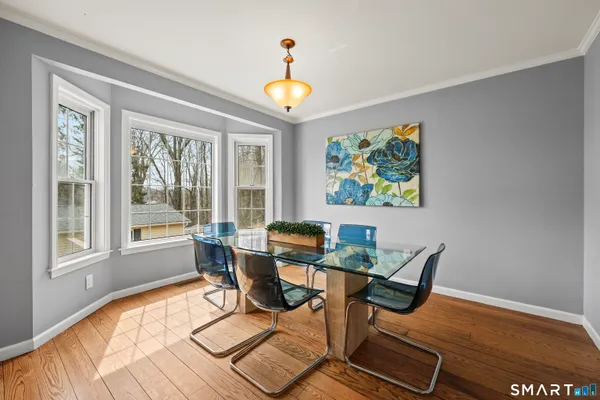 a dining room with furniture and wooden floor