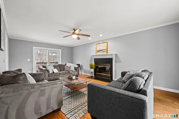 a living room with furniture a couch and a chandelier