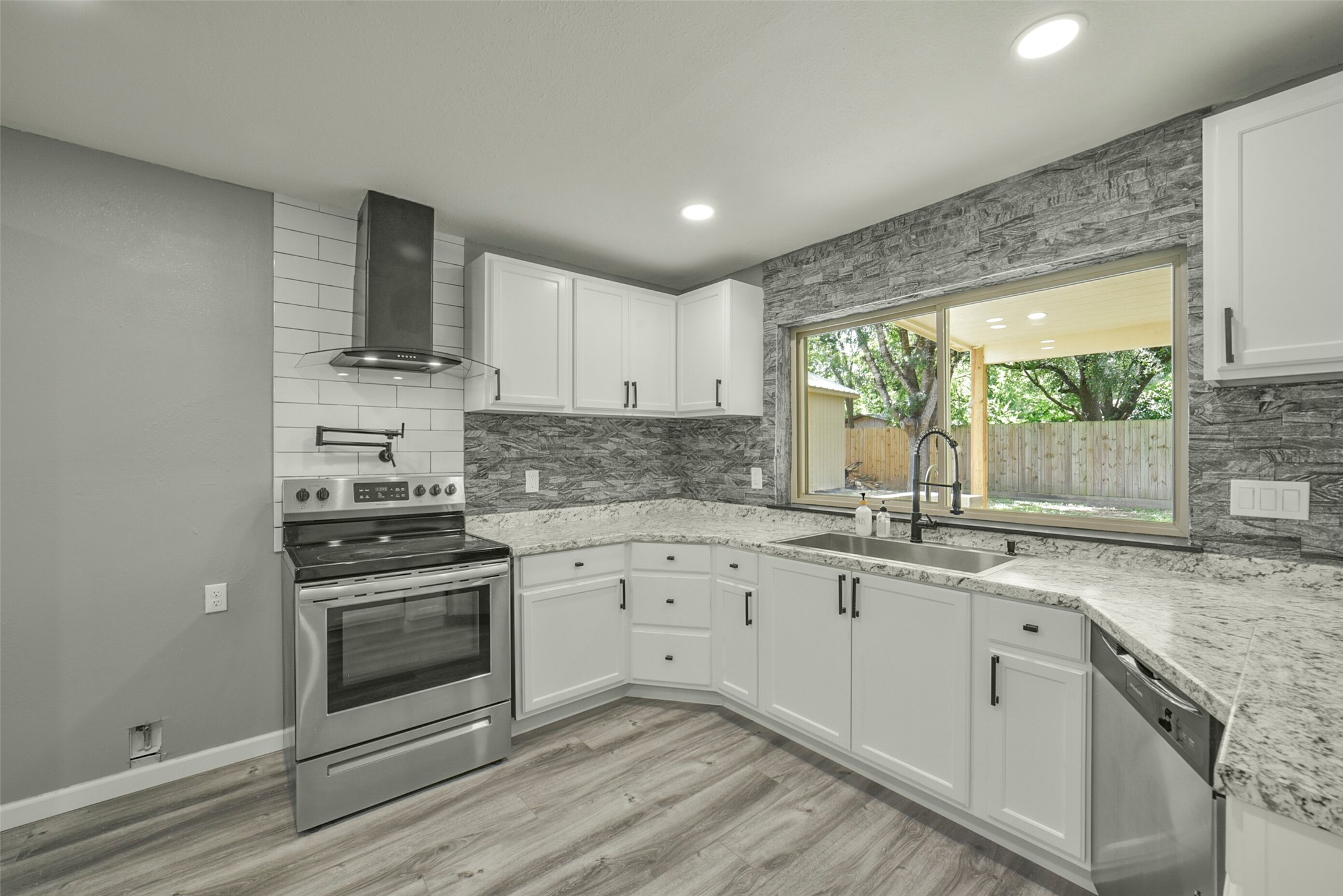 18606 Mellowgrove Lane Spring, TX 77379 - Photo 9 of 43 This functional kitchen features a pot filler & SS appliances overlooking the covered patio