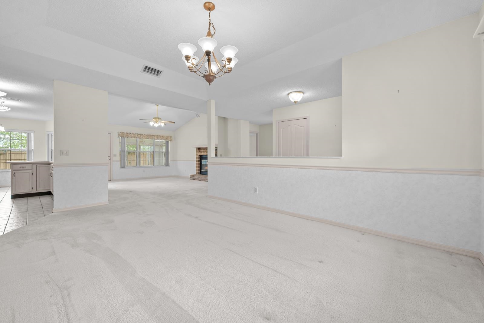 512 Moultrie Wells Road St. Augustine, FL 32086 - Photo 12 of 51 a view of an empty room and a chandelier fan