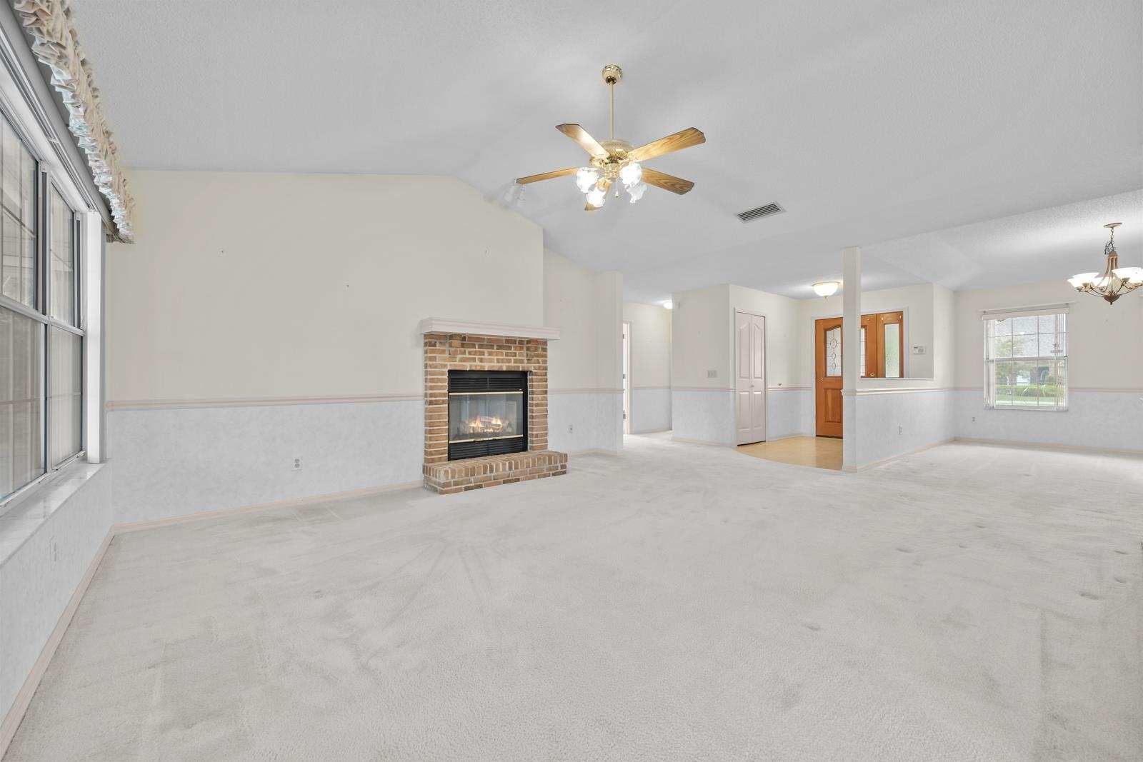 512 Moultrie Wells Road St. Augustine, FL 32086 - Photo 13 of 51 an empty room with a fireplace and fan