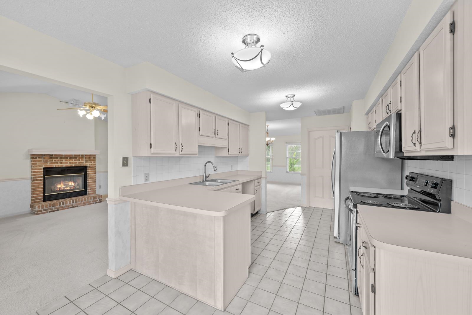 512 Moultrie Wells Road St. Augustine, FL 32086 - Photo 16 of 51 a kitchen with a sink cabinets and appliances
