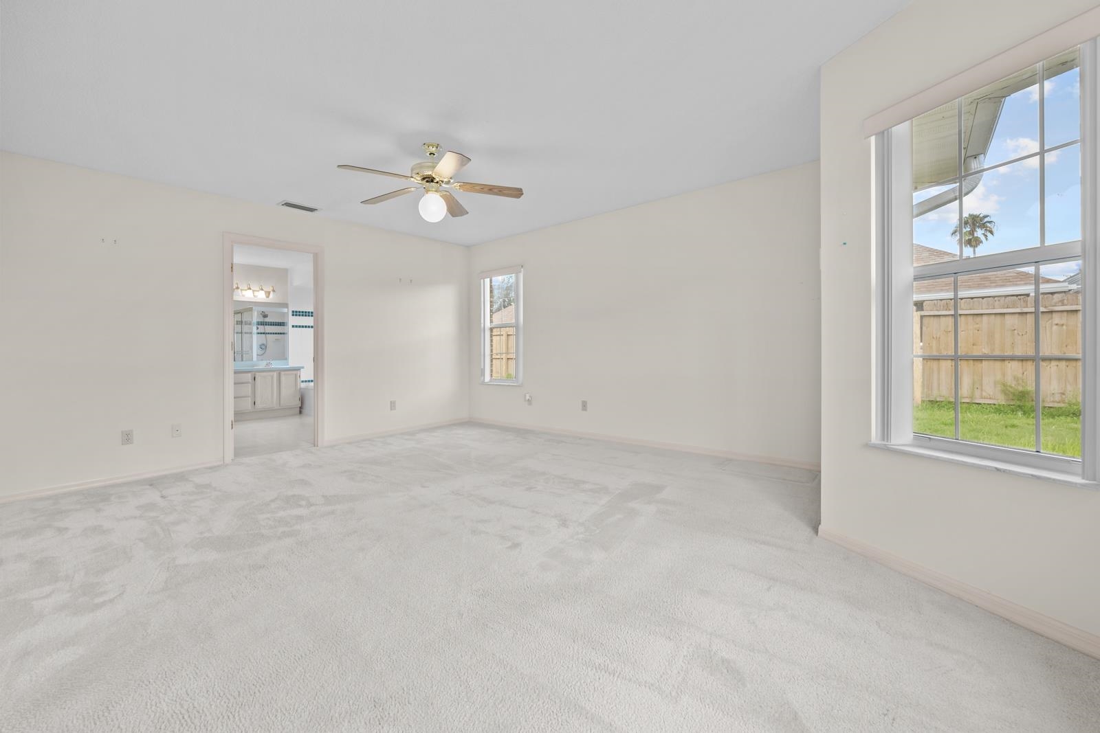 512 Moultrie Wells Road St. Augustine, FL 32086 - Photo 20 of 51 an empty room with windows and chandelier fan