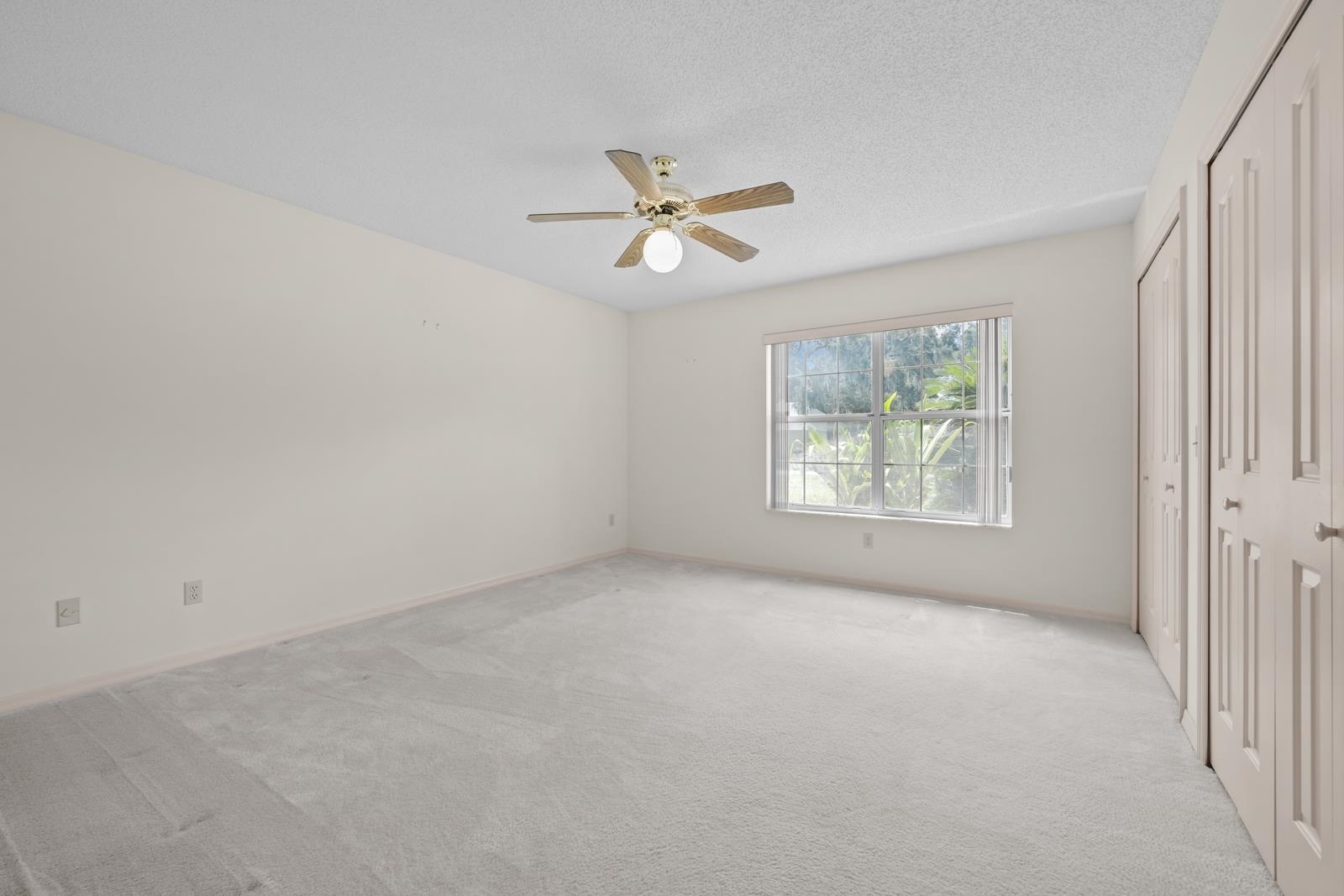 512 Moultrie Wells Road St. Augustine, FL 32086 - Photo 25 of 51 an empty room with windows and fan