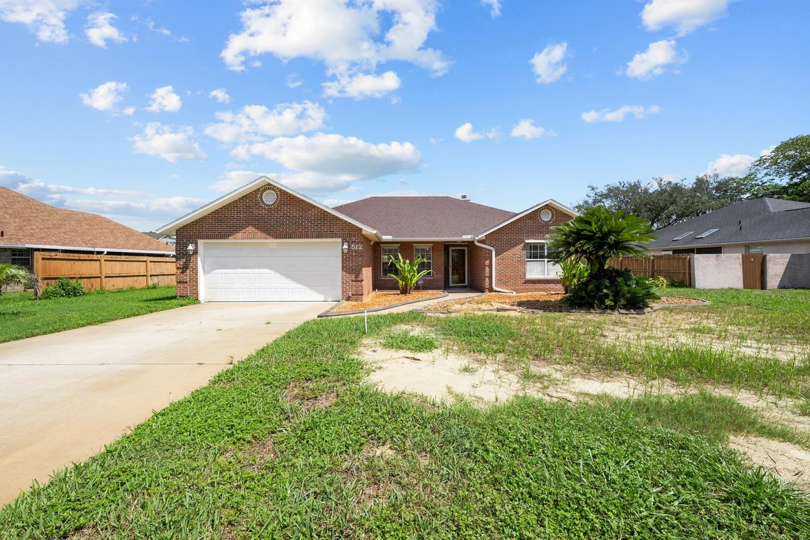 512 Moultrie Wells Road St. Augustine, FL 32086 - Photo 3 of 51 a front view of a house with a yard