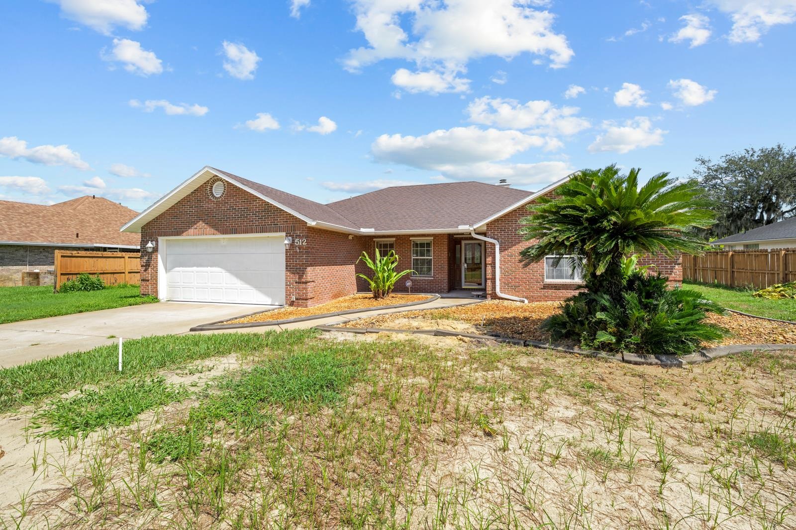 512 Moultrie Wells Road St. Augustine, FL 32086 - Photo 37 of 51 a front view of a house with a yard and garage
