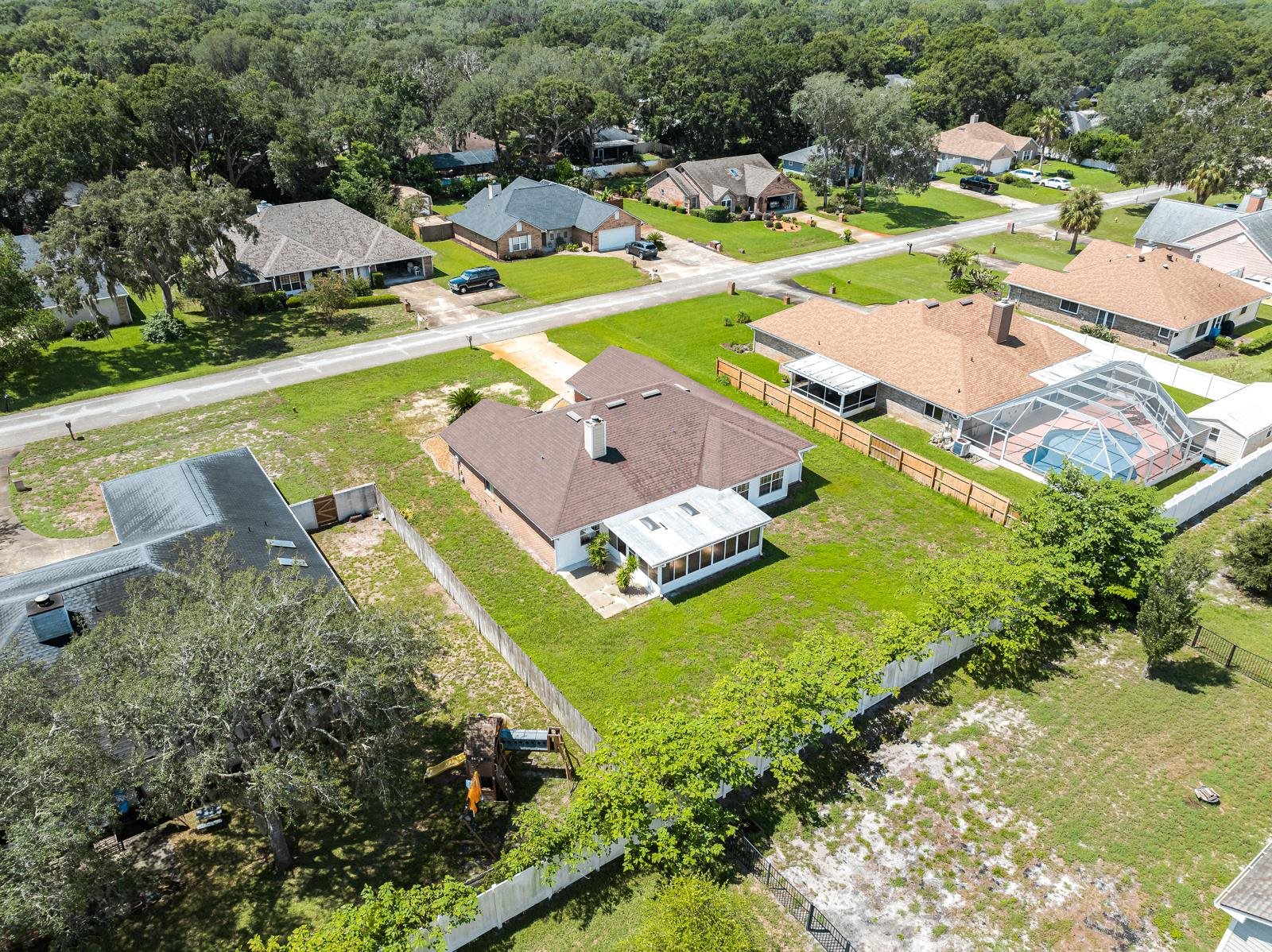 512 Moultrie Wells Road St. Augustine, FL 32086 - Photo 46 of 51 an aerial view of a house with a swimming pool outdoor seating and yard